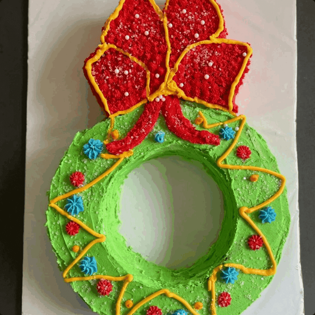 Colorful Christmas wreath cake with festive decorations.