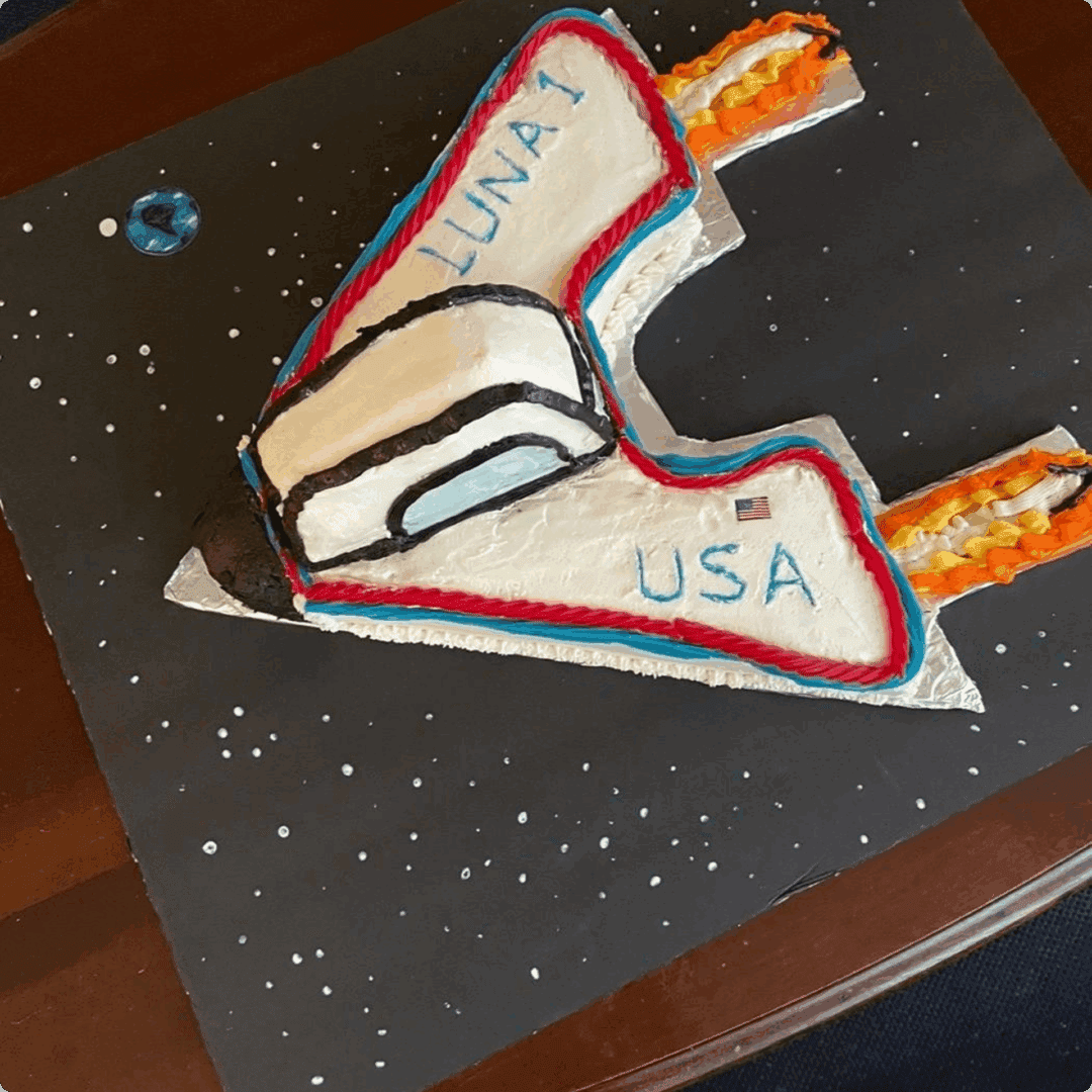 Model of the NASA Space Shuttle on a starry background.