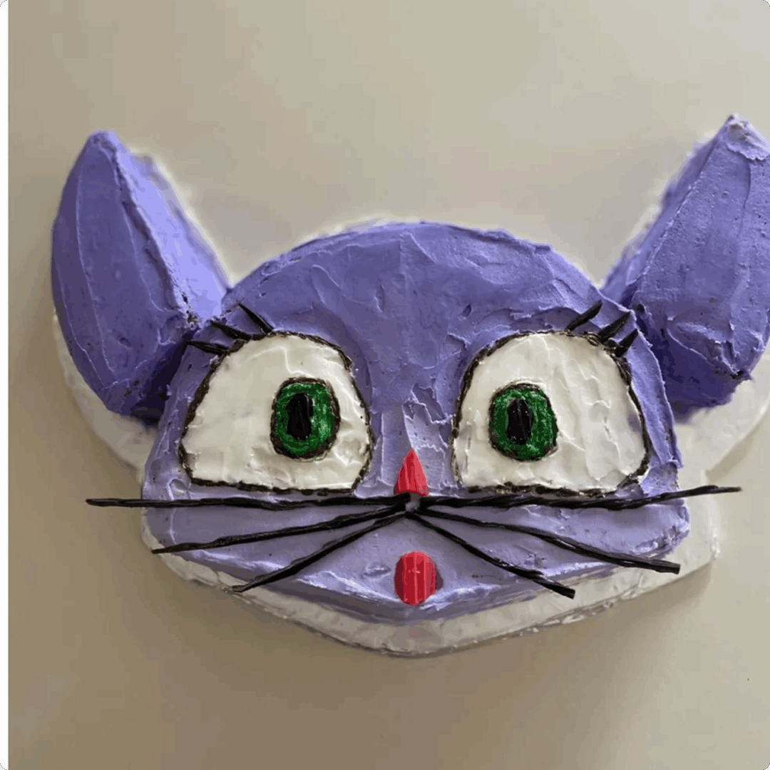 Handmade cat mask with glasses and large green eyes.